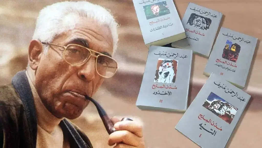 عبد الرحمن منيف يحمل غليونه وبجواره إصدارات سلسلة مدن الملح الخمسة